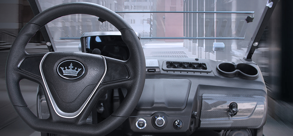 Driver's seat, steering wheel, and dash of the golf cart