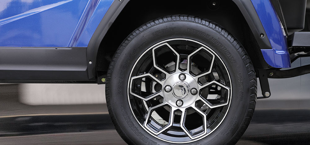 Close-up of the alloy wheel and Evolution radial tire on the golf cart